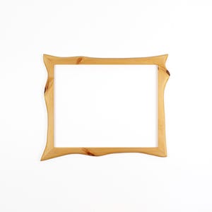 May include: A rectangular picture frame crafted from light-coloured natural wood. The frame features a distinct live edge design on the vertical sides, showcasing visible wood grain patterns and knots throughout the smooth, polished surface.