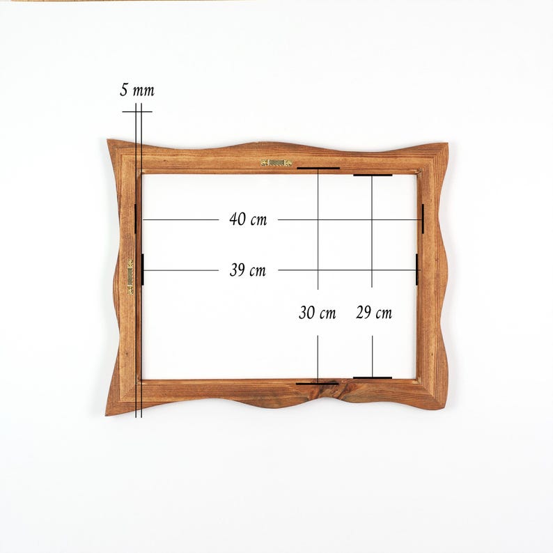 May include: A wooden picture frame with a wavy edge. The frame's interior dimensions are 11.4 inches by 15.7 inches. The frame's exterior dimensions are 15.7 inches by 18.1 inches. The frame is 0.2 inches thick.