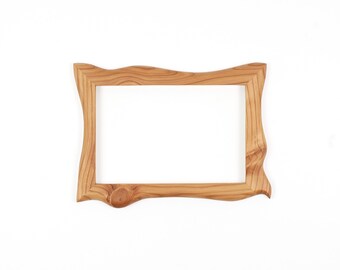 May include: A rectangular wooden picture frame featuring a natural light brown wood grain pattern. The frame has an irregular, wavy outer edge and a prominent circular wood knot detail on the bottom left corner of the frame border.