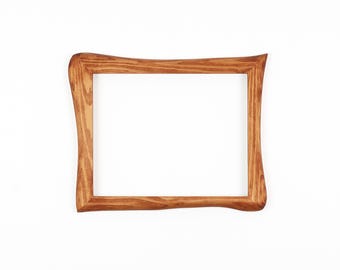 May include: A rectangular wooden picture frame with a natural wood grain finish. The frame has a unique, curved design on the corners and edges, and is set against a white background.