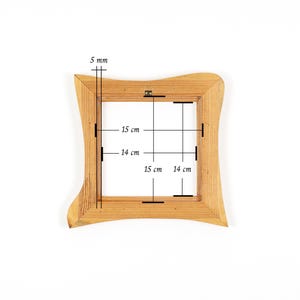 Puede incluir: Un marco de fotos cuadrado de madera con un borde exterior ondulado. El marco es de color marr&oacute;n claro y tiene medidas de 5 mm de grosor, 15 cm y 14 cm en el interior. El marco est&aacute; sobre un fondo blanco.