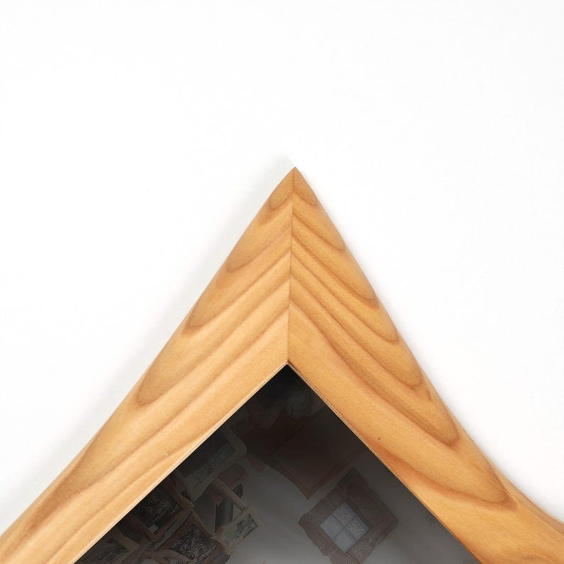 May include: A wooden picture frame with a light brown finish. The frame is triangular, with a mitered corner. The wood grain is visible. The frame is set against a white background.