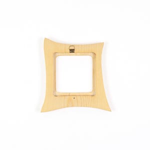 May include: A light-coloured wooden picture frame with a square central opening and curved, concave outer edges. The frame features a visible natural wood grain pattern and includes a small, centred metal hanging bracket on the top edge.