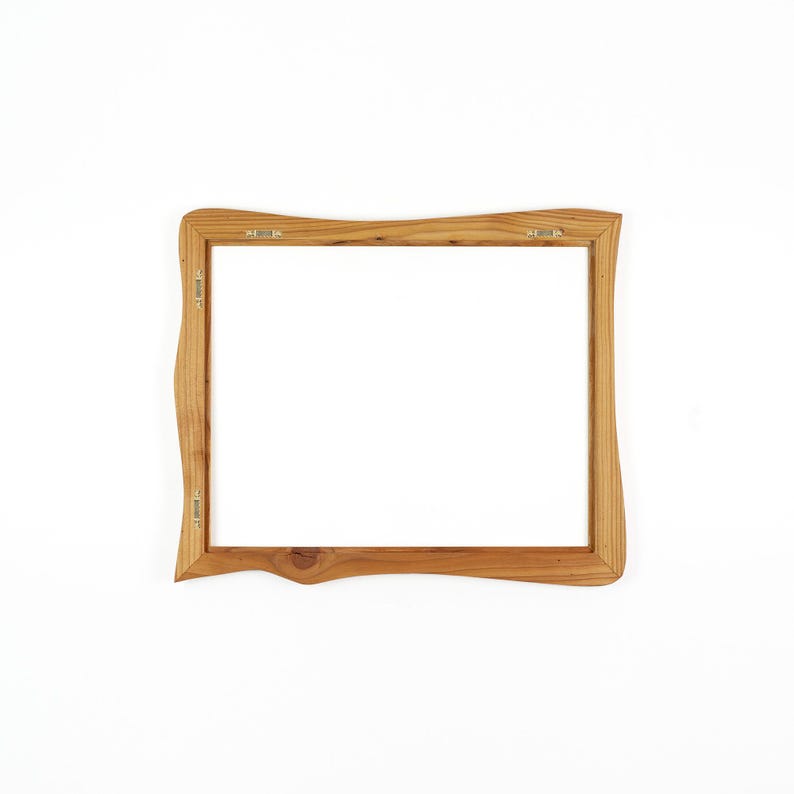 May include: A rectangular wooden picture frame with natural light brown wood grain and wavy, organic edges. The frame features four metal sawtooth hangers attached to the back inner border, allowing for both horizontal and vertical wall mounting.