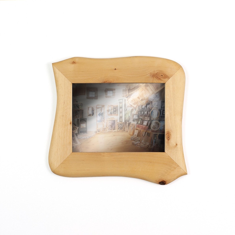 May include: A rectangular picture frame crafted from light-coloured natural wood with a smooth, wavy, and organic outer edge. The frame features visible wood grain patterns and small knots, surrounding a central rectangular opening.