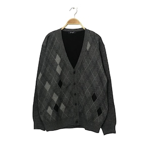 May include: A gray argyle cardigan sweater with a V-neck and button-down front. The sweater features a classic diamond pattern in shades of gray and black. It is hanging on a wooden hanger against a white background.