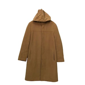 May include: A long, tan hooded coat. The coat features a simple design with a hood, long sleeves, and a knee-length hem. The coat has two pockets and a button closure. The coat is made of a soft, wool-like material.