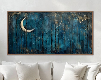 May include: A white couch with two pillows sits in front of a painting of a dark blue forest with a crescent moon and gold accents. A wooden coffee table with a woven basket and a bowl of stones sits in front of the couch.