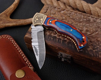 Folding pocket knife with Damascus blade, wood and brass handle, engraved eagle + leather sheath