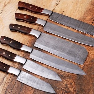 May include: Set of six kitchen knives with wooden handles. The knives have a Damascus steel blade with a wavy pattern.