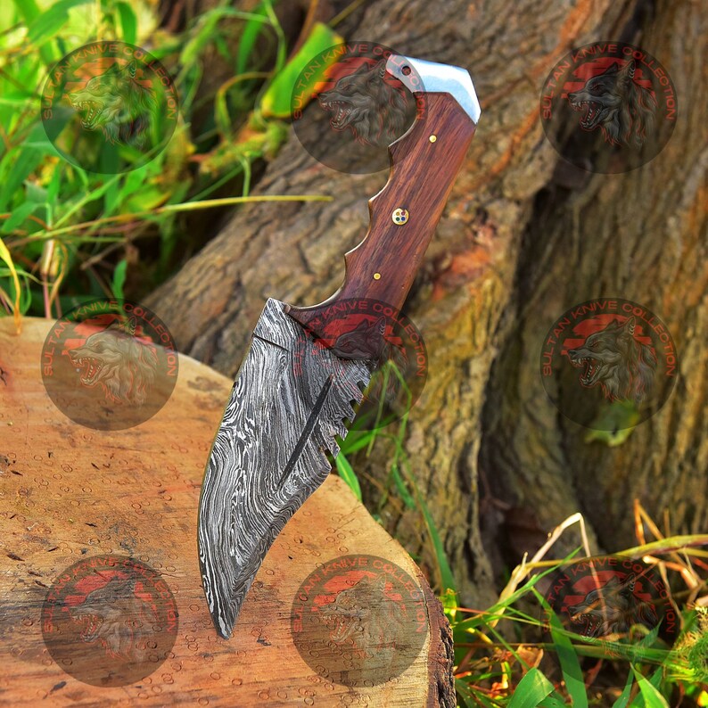 May include: A Damascus steel knife with a wooden handle. The blade has a serrated edge and a decorative pattern. The knife is resting on a wooden surface.