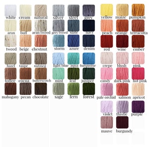 May include: A color chart featuring a variety of yarn colors. The chart displays swatches of yarn in shades like white, cream, natural, silver, and steel. Other colors include yellow, orange, red, pink, and purple. Each swatch is labeled with its color name.