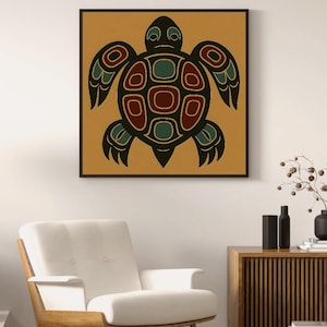 May include: A framed print featuring a stylized turtle design. The artwork showcases a black turtle silhouette with red and teal accents on a mustard-yellow background. The print is displayed above a white armchair and wooden cabinet.