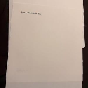 May include: A stack of white letterhead paper featuring the black printed text Seven Oaks Software, Inc. at the top. The bottom of the page displays the address P.O. Box 411, Rhinebeck, NY 12572 and the phone number (914) 876-7222 in black ink.
