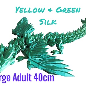 May include: A large, green, origami dragon made of silk. The dragon is 40 cm long and has a spiky, textured design. The text "YELLOW + GREEN SILK" and "Large Adult 40cm" is visible in the image.