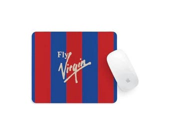 May include: A rectangular mouse mat featuring vertical red and blue stripes with the white text Fly Virgin printed in the centre, accompanied by a white computer mouse positioned on the right side of the mouse mat surface.