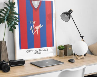 May include: A framed vertical poster featuring a graphic illustration of a red and blue striped football shirt with a V-neck collar. The text Fly Virgin is printed in white across the chest, with Crystal Palace 1988/90 printed below the shirt.