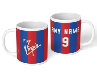 May include: Two white ceramic mugs featuring vertical red and blue stripes. One mug displays the text Fly Virgin in white script. The other mug features the text ANY NAME in white block letters above the white number 9 on a red and blue striped background.