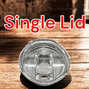 May include: A clear plastic lid with a single opening for a straw. The lid is designed for a tumbler or travel mug. The text "Single Lid" is visible in the image.
