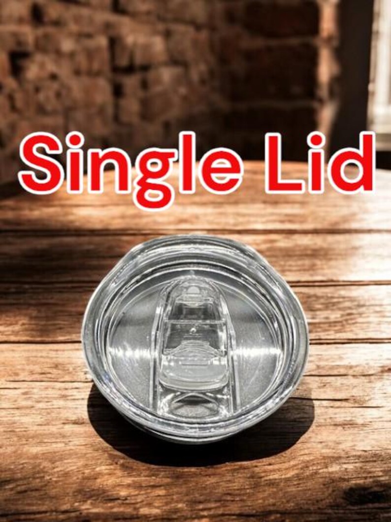 May include: A clear plastic lid with a single opening for a straw. The lid is designed for a tumbler or travel mug. The text "Single Lid" is visible in the image.