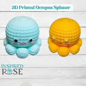 May include: Two 3D-printed octopus spinners, one light blue and one yellow, sit side-by-side. Each has a textured, rounded head and eight curled tentacles. The light blue octopus has black eyes and a pink smile. The text "3D Printed Octopus Spinner" is above the spinners.