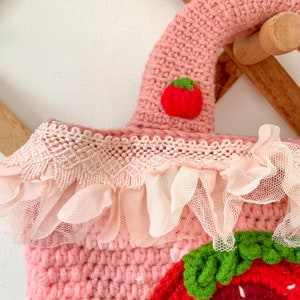 Strawberry Crochet Handbag or Shoulder Bag.
This crochet bag has a pink geometric base combined with a strawberry pattern in the middle of it.  you can choose the style you want.