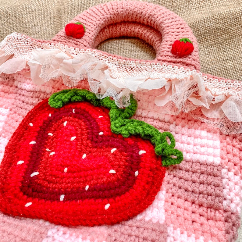 Strawberry Crochet Handbag or Shoulder Bag.
This crochet bag has a pink geometric base combined with a strawberry pattern in the middle of it.  you can choose the style you want.