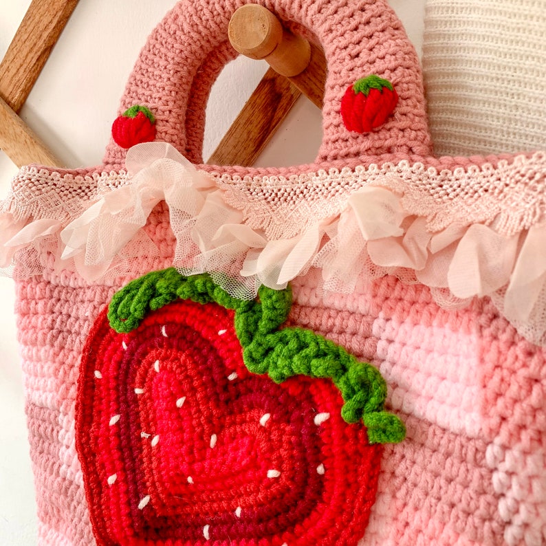 Strawberry Crochet Handbag or Shoulder Bag.
This crochet bag has a pink geometric base combined with a strawberry pattern in the middle of it.  you can choose the style you want.