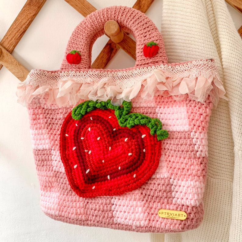Strawberry Crochet Handbag or Shoulder Bag.
This crochet bag has a pink geometric base combined with a strawberry pattern in the middle of it.  you can choose the style you want.