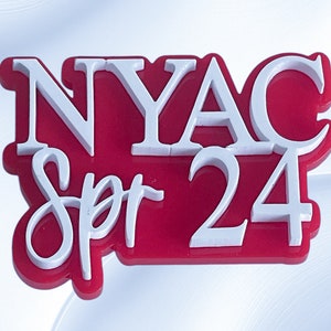May include: A red and white acrylic sign with the text "NYAC Spr 24" in white lettering.