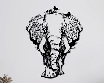 May include: Black and white silhouette wall art of an elephant's head with branches forming the outline of the elephant. The elephant's head is facing forward with its trunk curled up. The art is mounted on a white wall with a wooden shelf and plants below.