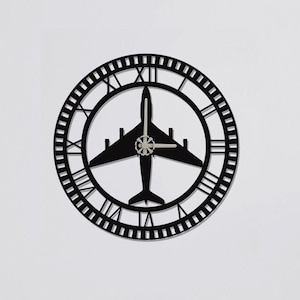 May include: Black wall clock with Roman numeral markings and an airplane silhouette in the center.