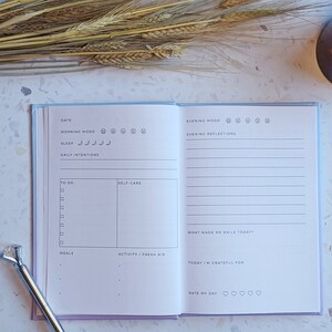 May include: A light blue daily planner with sections for date, morning mood, sleep, daily intentions, to do, self-care, meals, activity, fresh air, evening mood, evening reflections, what made me smile today, today I'm grateful for, and rate my day.