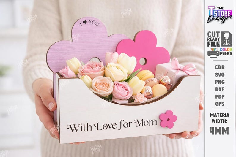 May include: A wooden flower box with the text "With Love for Mom" and a pink flower accent. The box is filled with pink and yellow flowers, macarons, and a small gift box. The top of the box has a pink cloud-shaped design with the text "I &hearts; YOU".