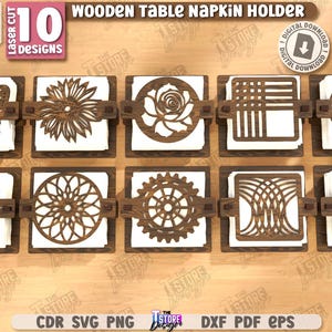 May include: Ten wooden table napkin holders with laser-cut designs. Each holder is 3mm thick and 1/8 inch in size. The designs include a butterfly, flower, rose, geometric patterns, and more. The holders are made of dark brown wood and hold white napkins.