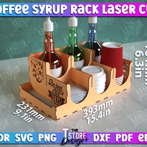 May include: Laser cut wooden syrup rack with four bottle slots, two cup holders, and a napkin holder. The rack is 15.4 inches wide, 9.1 inches deep, and 6.3 inches tall. The rack has a sign that says "Be kind, it's a bad day for everyone".