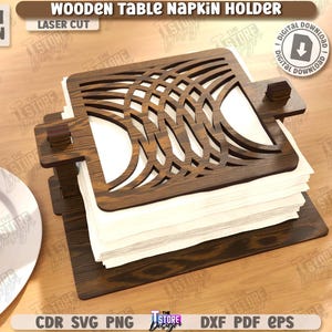 May include: A wooden table napkin holder with a laser-cut design. The holder is dark brown and holds a stack of white napkins. The text "WOODEN TABLE NAPKIN HOLDER" and "LASER CUT" are visible.