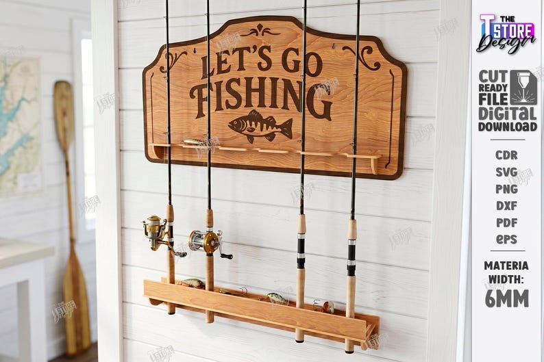 May include: Wooden fishing rod holder with the text "LET'S GO FISHING" and a fish graphic. The holder has slots for rods and a lower shelf for lures. Several fishing rods are displayed. The sign is mounted on a white wall.