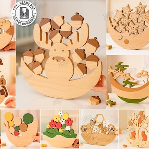 Puede incluir: Una colección de diez juguetes de equilibrio de madera con varios diseños, incluyendo bellotas, estrellas y flores. Cada juguete está hecho de madera clara y presenta una base curva. La imagen también incluye el texto "CUT READY FILE" y "10 Designs".