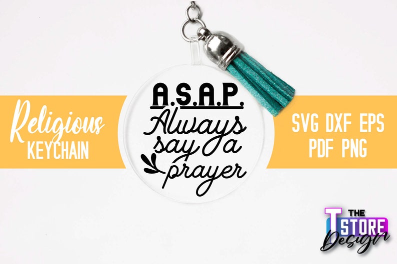 Pu&ograve; includere: Un portachiavi rotondo bianco con un fiocco turchese. Il portachiavi ha il testo nero che recita "A.S.A.P. Always say a prayer".