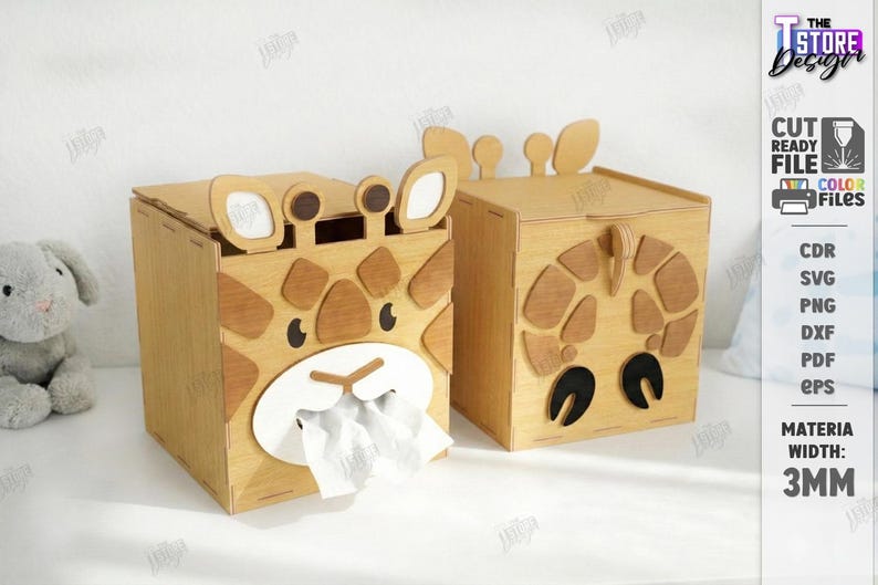 May include: Two wooden tissue box holders shaped like giraffes. One has tissues coming out of the mouth. The giraffe faces are made of light and dark brown wood. The boxes are on a white surface. The text on the right says "CUT READY FILE".