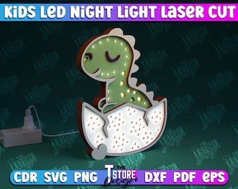 Può includere: Una luce notturna a forma di dinosauro verde con una base bianca a forma di uovo. Il dinosauro ha un occhio chiuso e una piccola bocca. La luce è in legno e ha un design tagliato al laser. La luce è collegata a una presa di corrente ed è accesa.