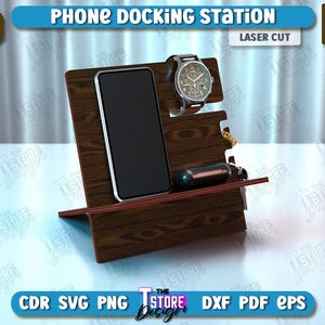 Op de afbeelding: Een houten telefoon laadstation met een gleuf voor een horloge en een klein compartiment voor andere items. Het station is lasergesneden uit 6 mm (1/4 inch) dik hout.