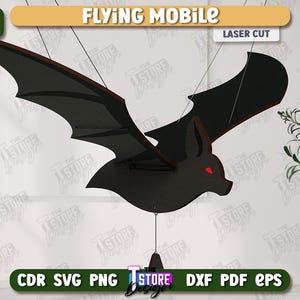 May include: A black bat-shaped flying mobile with red eyes, laser cut from wood. The mobile is suspended by thin strings. The words "FLYING MOBILE" and "LASER CUT" are visible. The image also includes the text "AGEN TOTO MACAU DOWNLOAD".