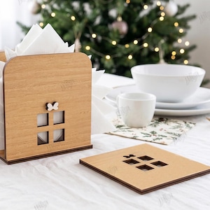 May include: A light brown wooden napkin holder and a matching square coaster, both featuring a cutout window design with a small butterfly accent. The napkin holder contains white paper napkins. The material width is labeled as 3mm.