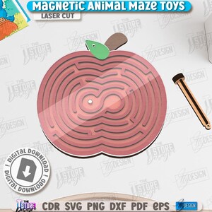 May include: A laser-cut wooden apple-shaped maze toy with a brown stem and green leaf. The maze has a series of concentric circular paths. A wooden stylus is included. The text "MAGNETIC ANIMAL MAZE TOYS" is at the top.