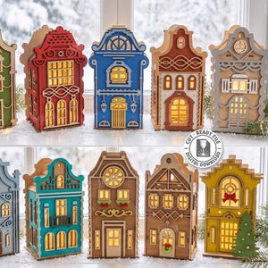 May include: Ten laser-cut wooden house models in various colours including green, red, blue, brown, and yellow. Each structure features intricate architectural details, windows, and doors with internal lighting. Text includes 10 DESIGNS, CUT READY FILE, and 3MM.