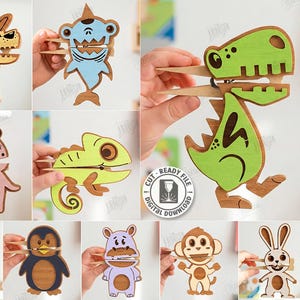 May include: A selection of ten laser-cut wooden animal designs, including a dog, shark, dinosaur, unicorn, chameleon, frog, penguin, hippo, monkey, and rabbit. Each design is held open with a clothes peg, showing the mouth or jaws.