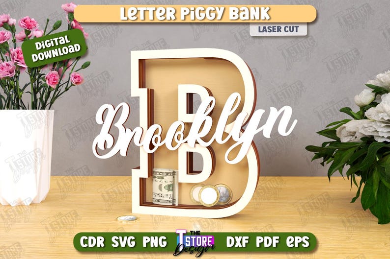 Puede incluir: Una hucha de madera con la letra "B" y el nombre "Brooklyn" en cursiva. El banco est&aacute; cortado con l&aacute;ser y contiene dinero y monedas. Las palabras "Letter Piggy Bank" y "Laser Cut" est&aacute;n en la parte superior.