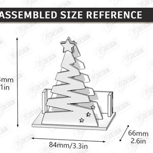 May include: A line drawing of an assembled Christmas tree ornament with a star topper and two small stars at the base. The diagram includes dimensions of 4.1 inches in height, 3.3 inches in width, and 2.6 inches in depth, labeled ASSEMBLED SIZE REFERENCE.